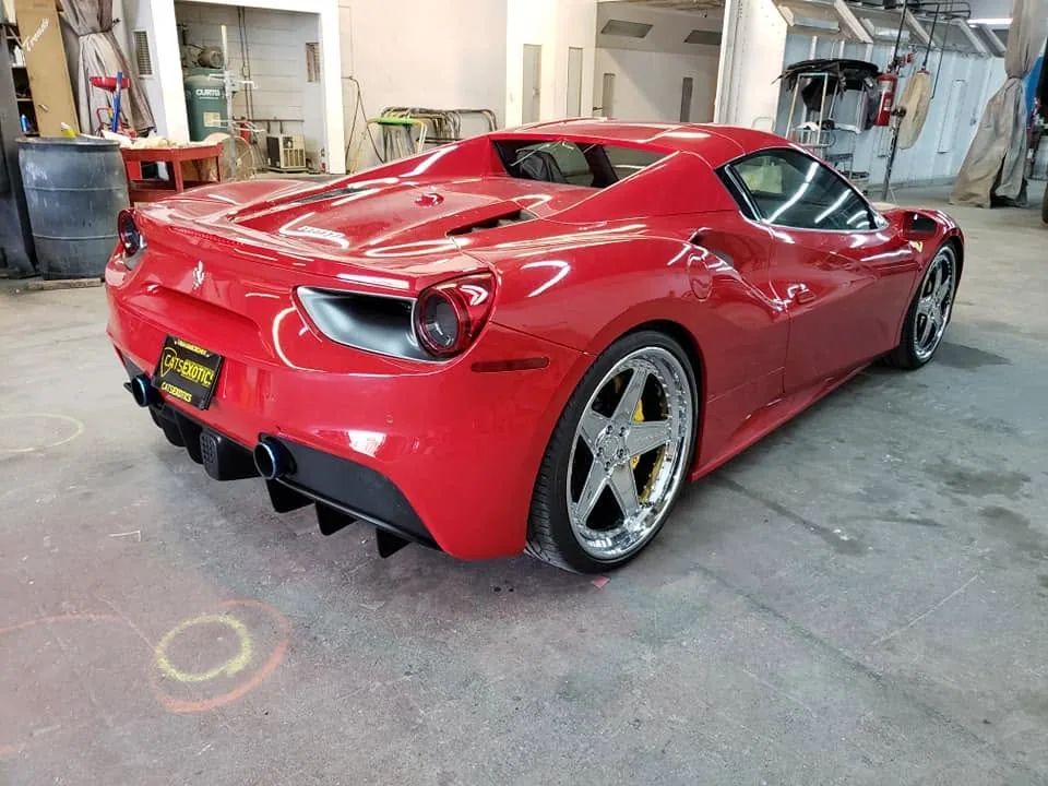 Red Ferrari 488 Spider in the Novix Autobody shop